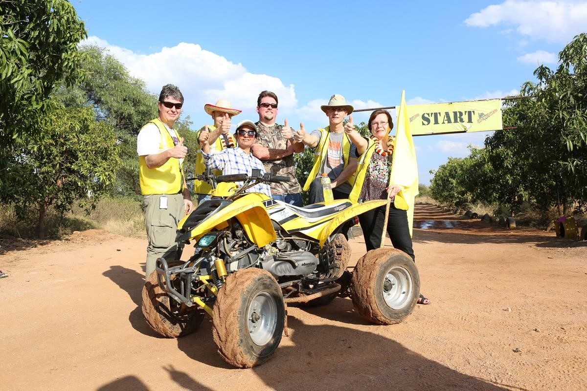 Employees standing by an ATV