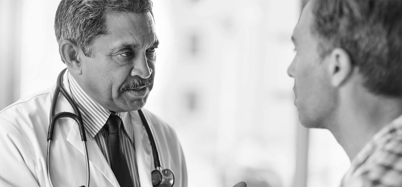 A doctor speaking to a patient