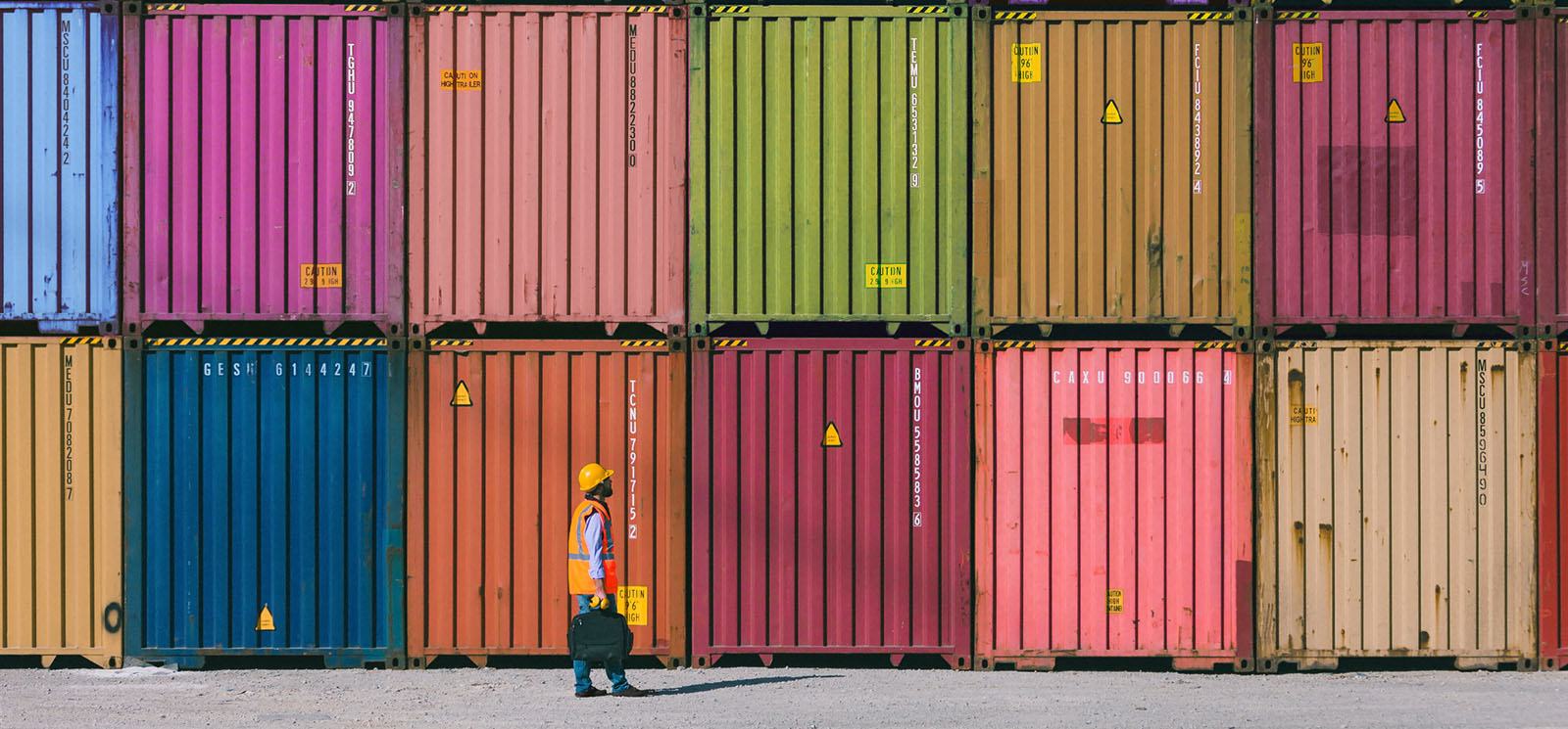 Maintenance Worker Working With Cargo Containers