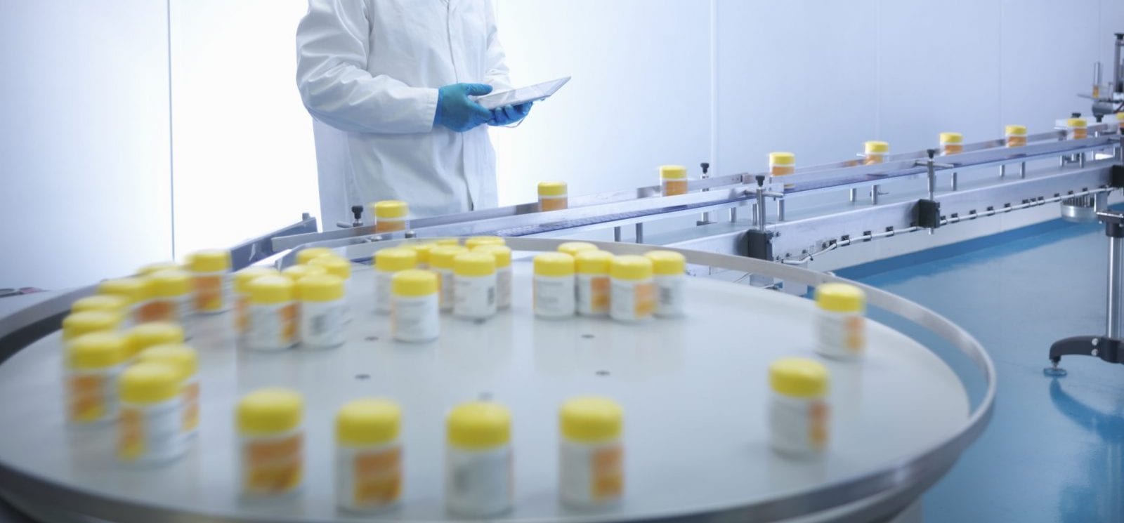 Worker inspecting packaging in pharmaceutical factory
